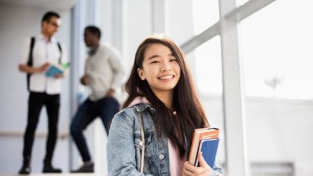 Student standing on staircase in NCI building